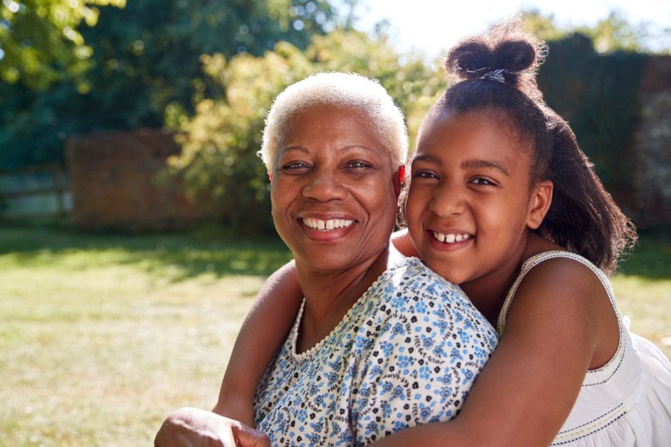 granddaughter embracing grandmother