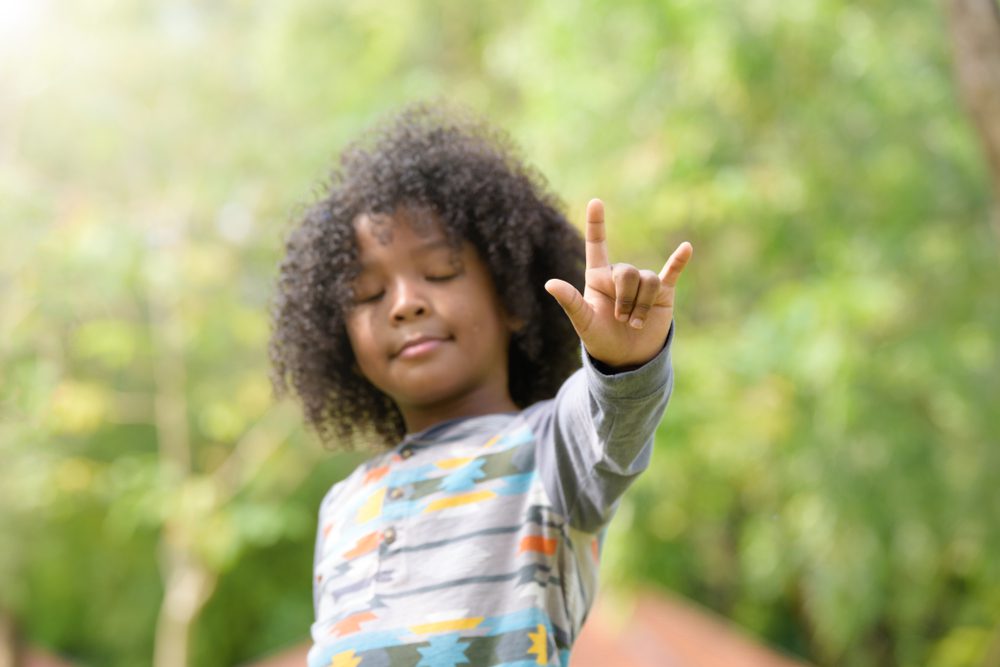 boy signing love in ASL