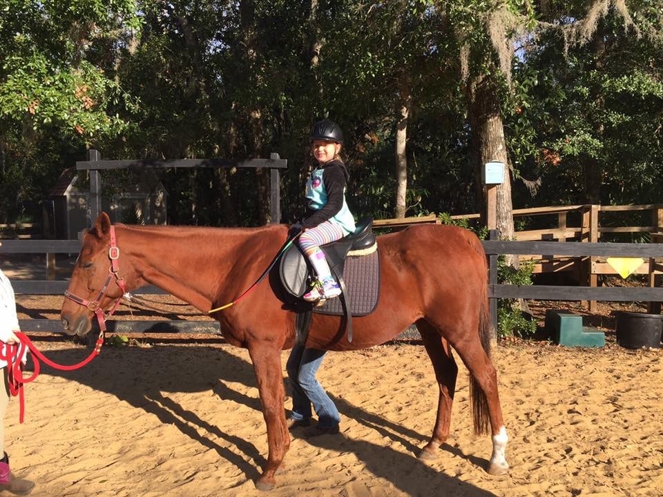 Girl with Cerebral Palsy taking horseback riding lessons at Whispering Meadows 