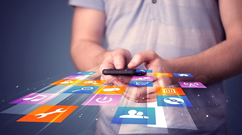 Person holding a smartphone looking at mobile apps to improve functionality