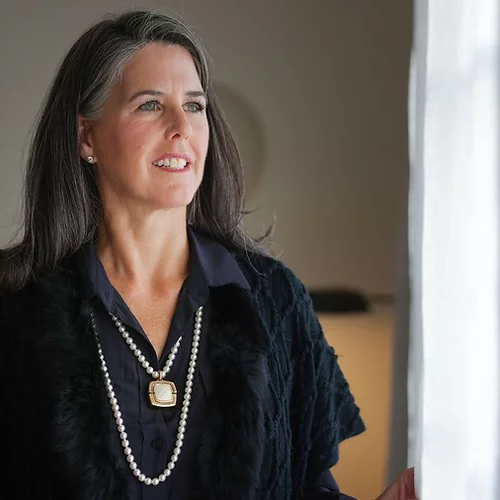 Woman wearing an emergency bluetooth pendant