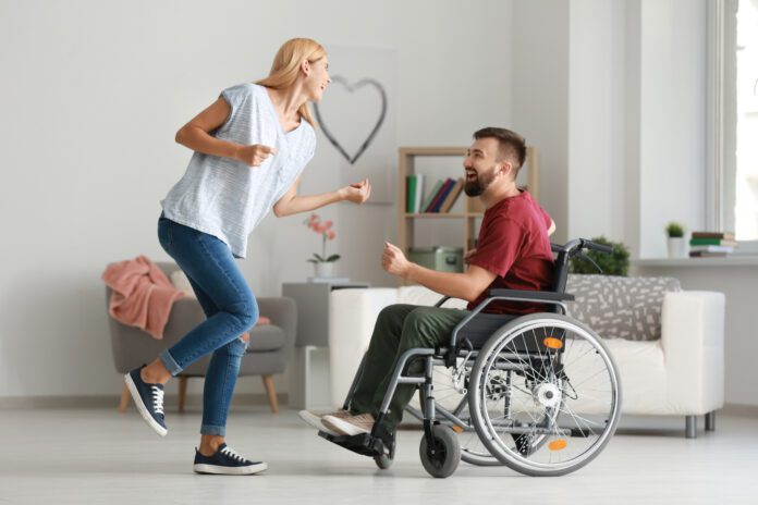interabled couple dancing and laughing