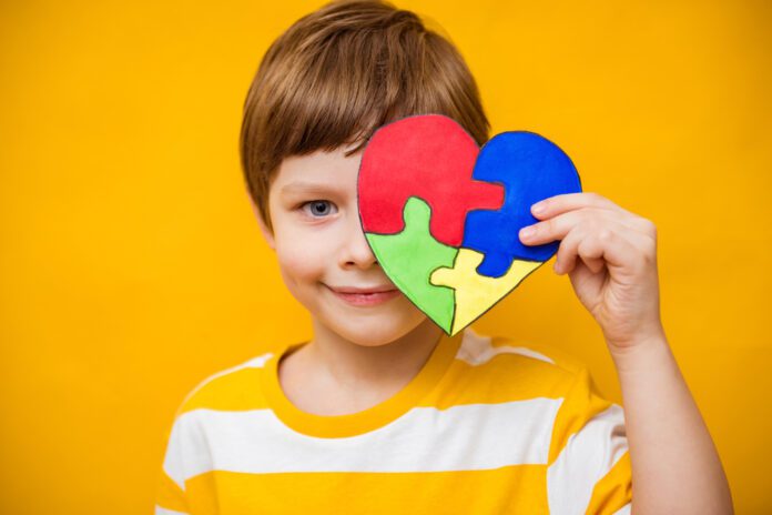 boy holding autism heart