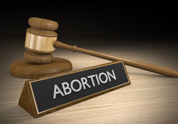 abortion sign next to judge gaffle