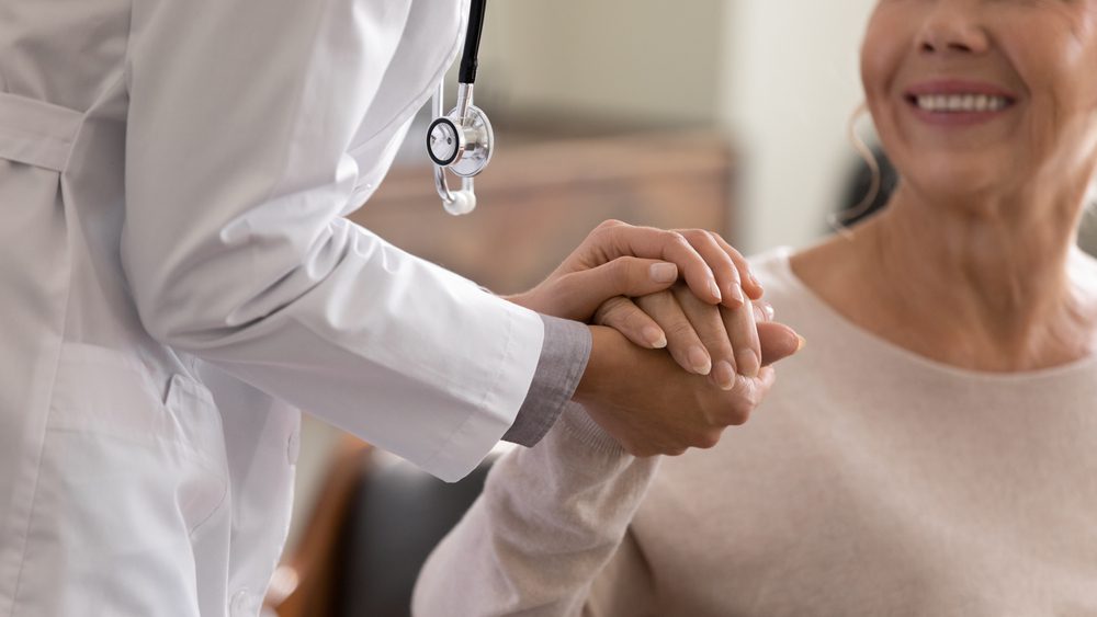 Doctor holding patient's hand