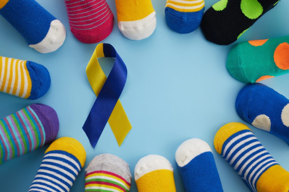 Mismatched socks align with World Down Syndrome Day; picture features colorful socks in circle with Down syndrome ribbon in center