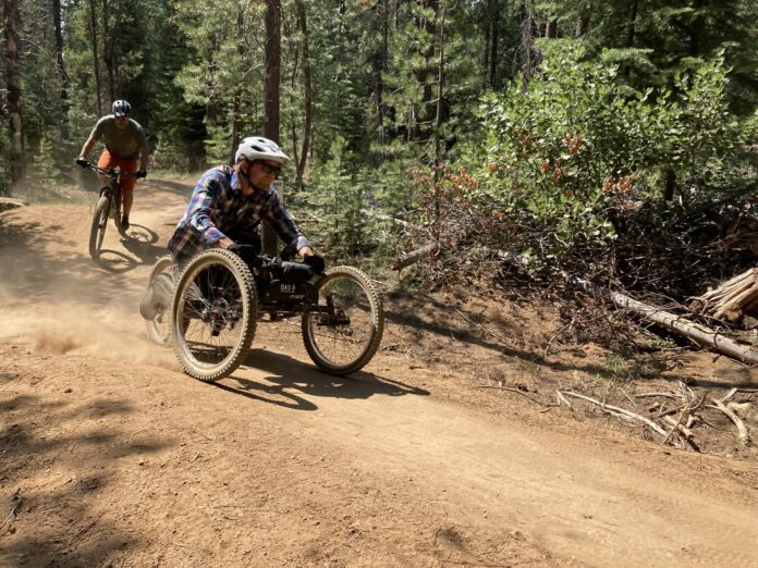 A mountain biker on an adaptive bike riding a trail near Bend, Oregon.