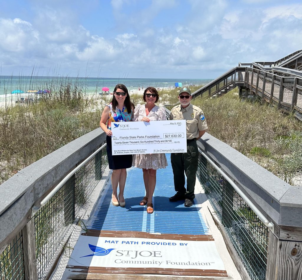 Reps from St. Joe Community Foundation award a grant check to reps from the Florida State Parks Foundation to make the an accessible beach in Florida more update to date.