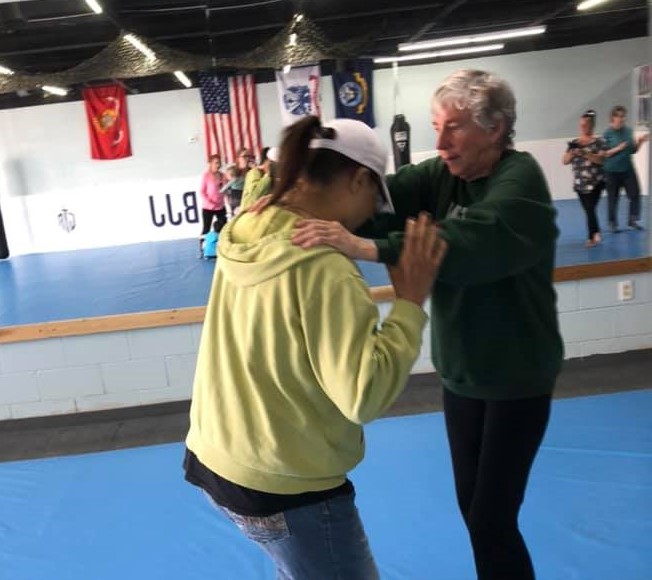 Two people with intellectual disabilities learn self-defense skills. 