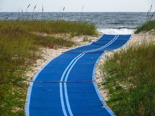 A blue accessible mat provides the public beach access, along the Gulf Coast of the Florida Panhandle.